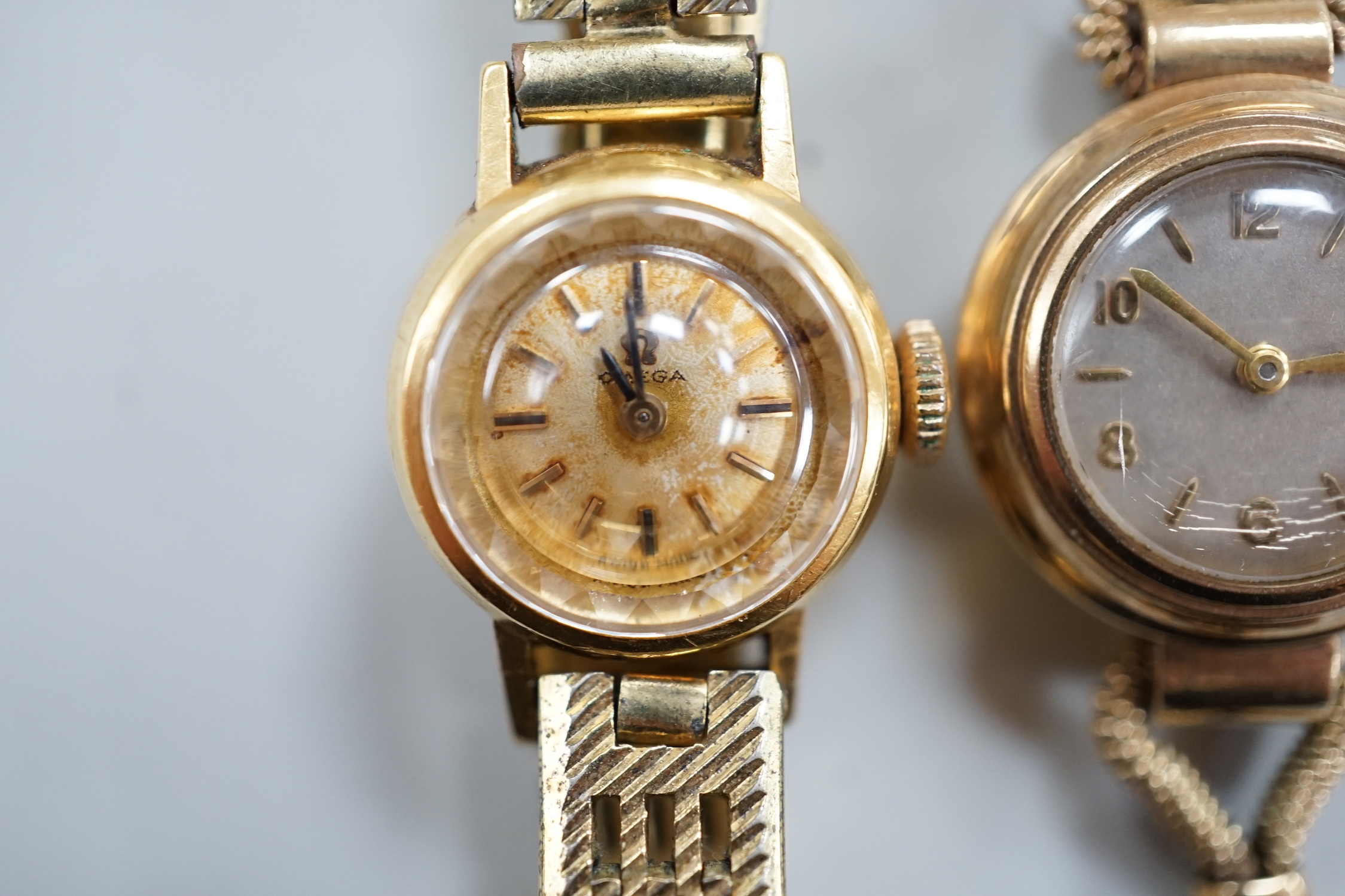 A lady's 9ct gold Omega manual wind wrist watch, on a gold plated bracelet, together with a lady's 9ct gold manual wind wrist watch, on a 9ct gold bracelet.